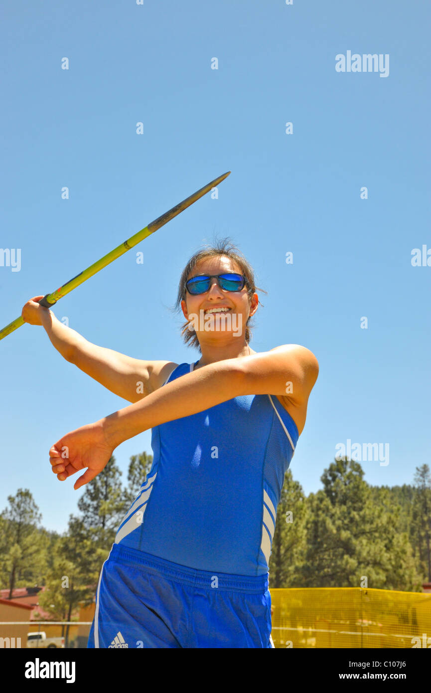 Teenage high school girl athlete participates in the javelin throw