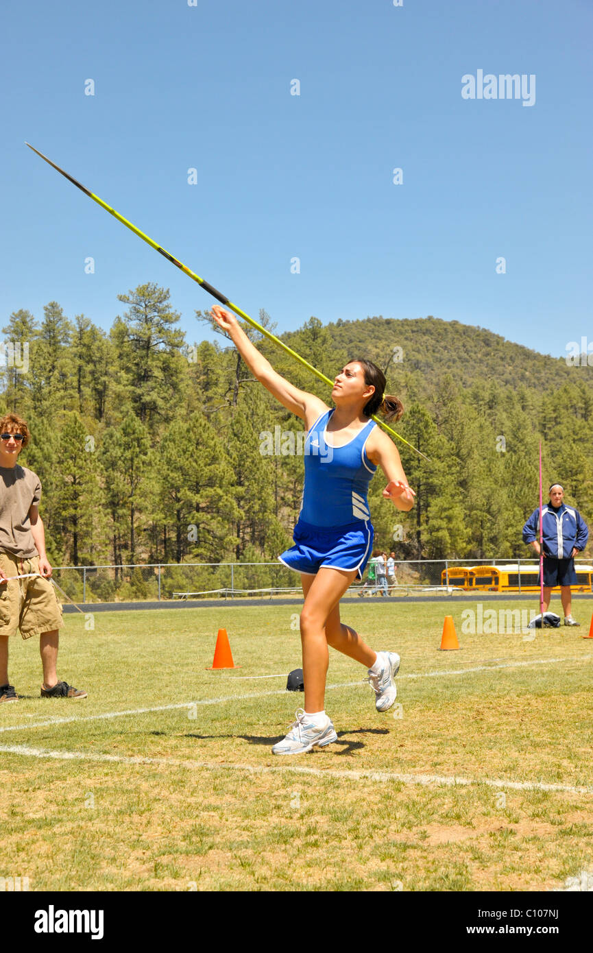 Teenage high school girl athlete participates in the javelin throw