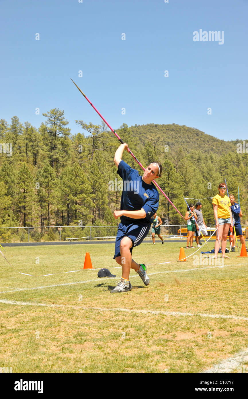 Teenage high school girl athlete participates in the javelin throw