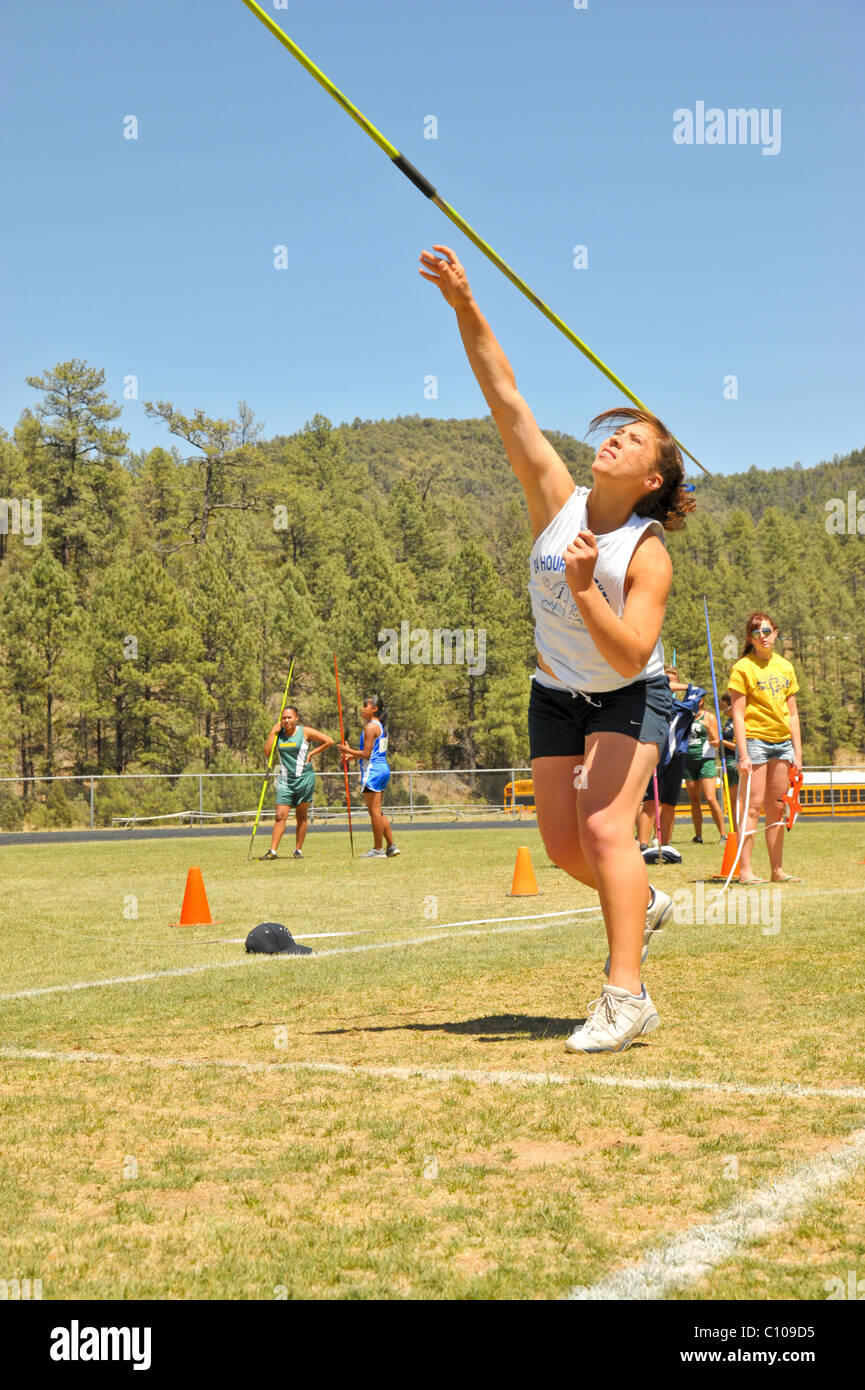 Teenage high school girl athlete participates in the javelin throw
