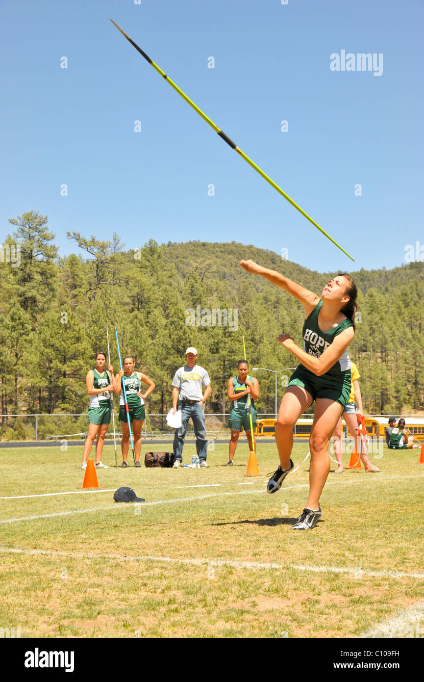 Teenage high school girl athlete participates in the javelin throw