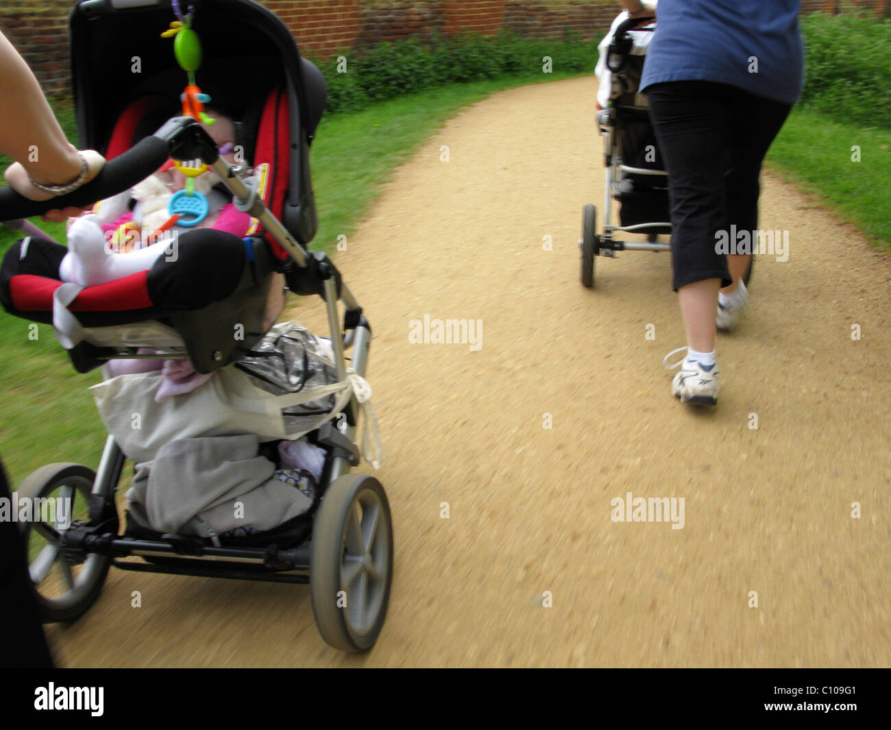 Mothers pushing buggy's during an outdoor exercise class Stock Photo