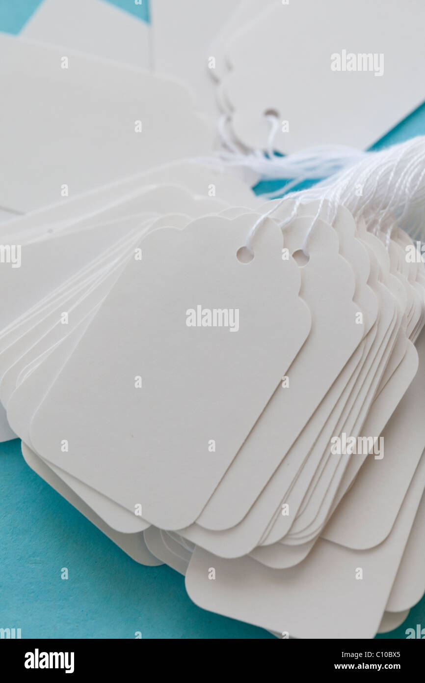 white blank price tag with string on blue cost Stock Photo