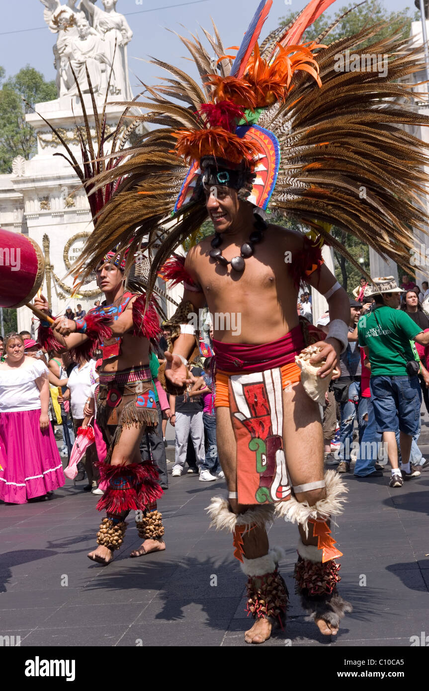 Prehispanic (Aztec) dance group performing during a parade in Mexico city Stock Photo