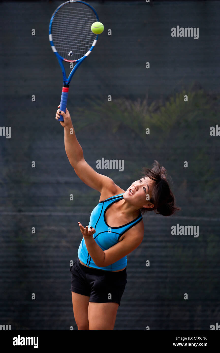 Japanese teenage tennis player in action. Stock Photo