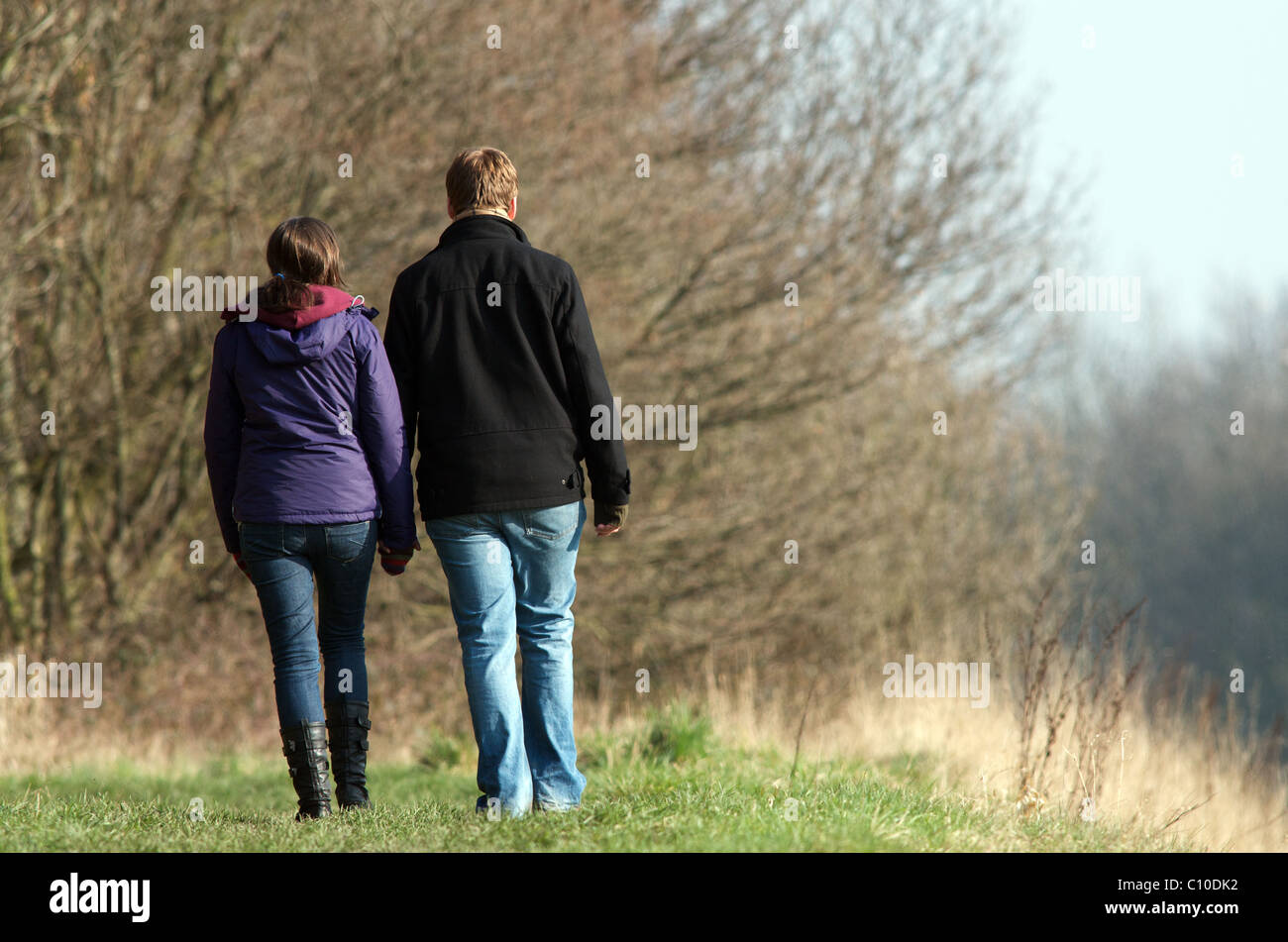 young couple holding hand while walking Stock Photo - Alamy