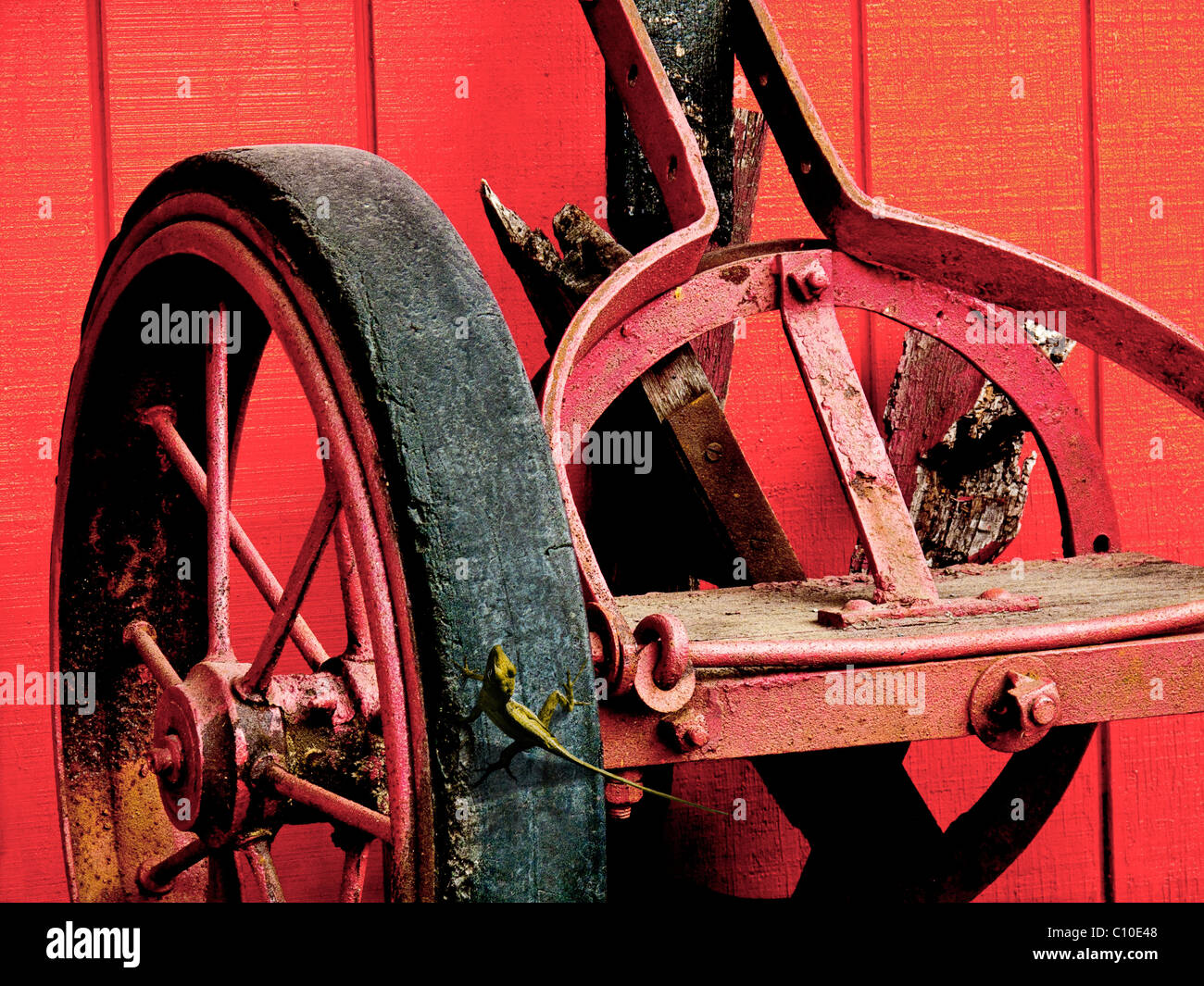 OLD FASHIONED RED RAILROAD HAND CART with green lizard Stock Photo