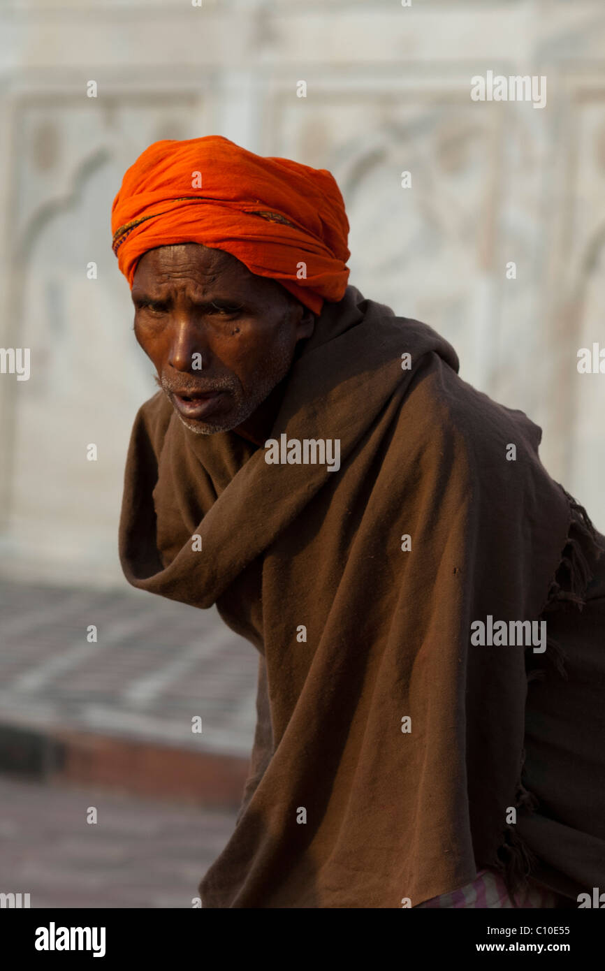 Portrait of an old Indian man in an orange turban outside Taj Mahal wall, Agra, India Stock Photo