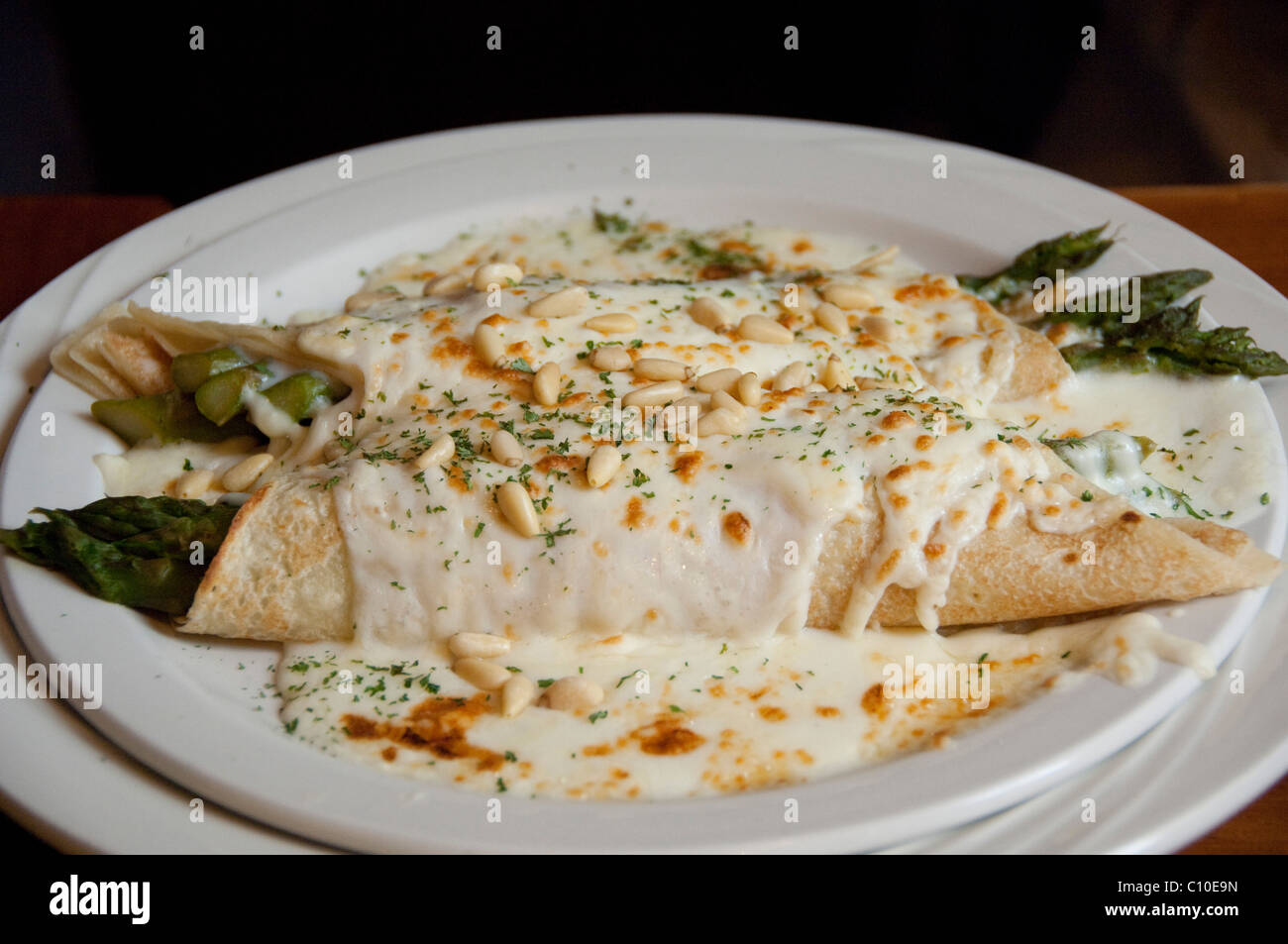 Canada, Quebec, Montreal. Typical French Canadian food, asparagus crepes  with cheese sauce & pine nuts Stock Photo - Alamy