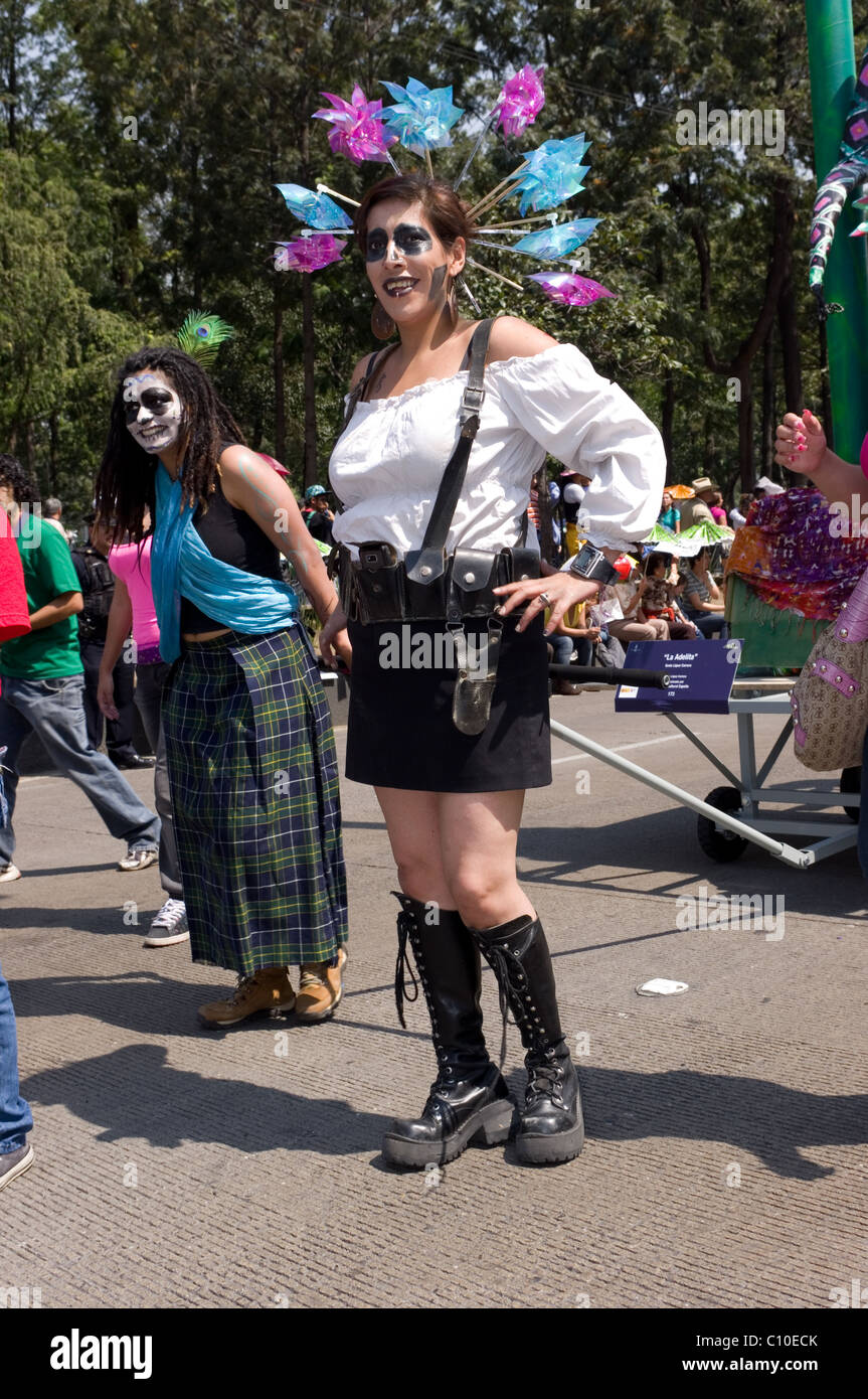 Two Mexican women with skull make up and some strange outfit during a parade in Mexico city Stock Photo