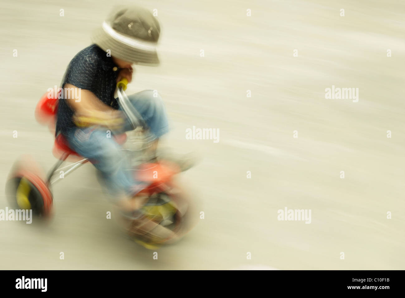 Boy on tricycle Stock Photo Alamy