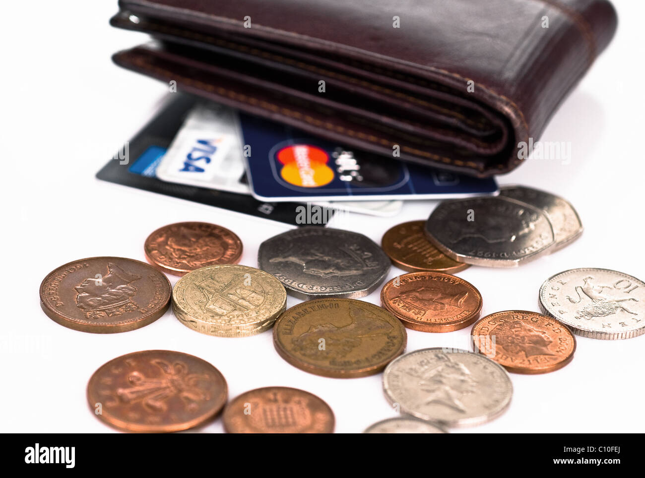 Empty wallet with credit cards- visa, mastercard, american express  and spilled pennies Stock Photo