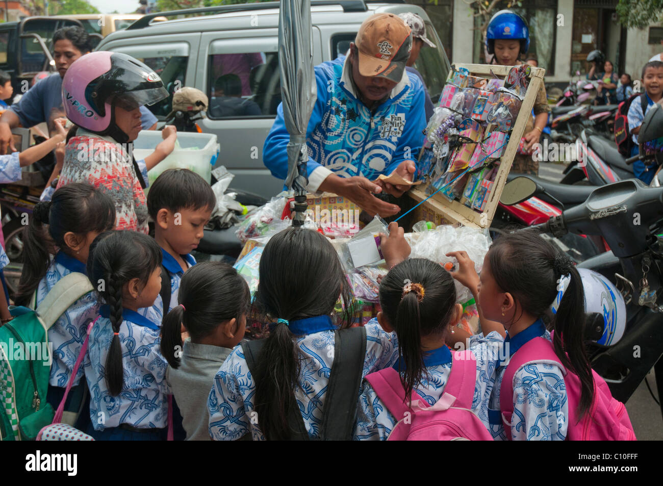 Indonesian primary school children buying after school treats from a