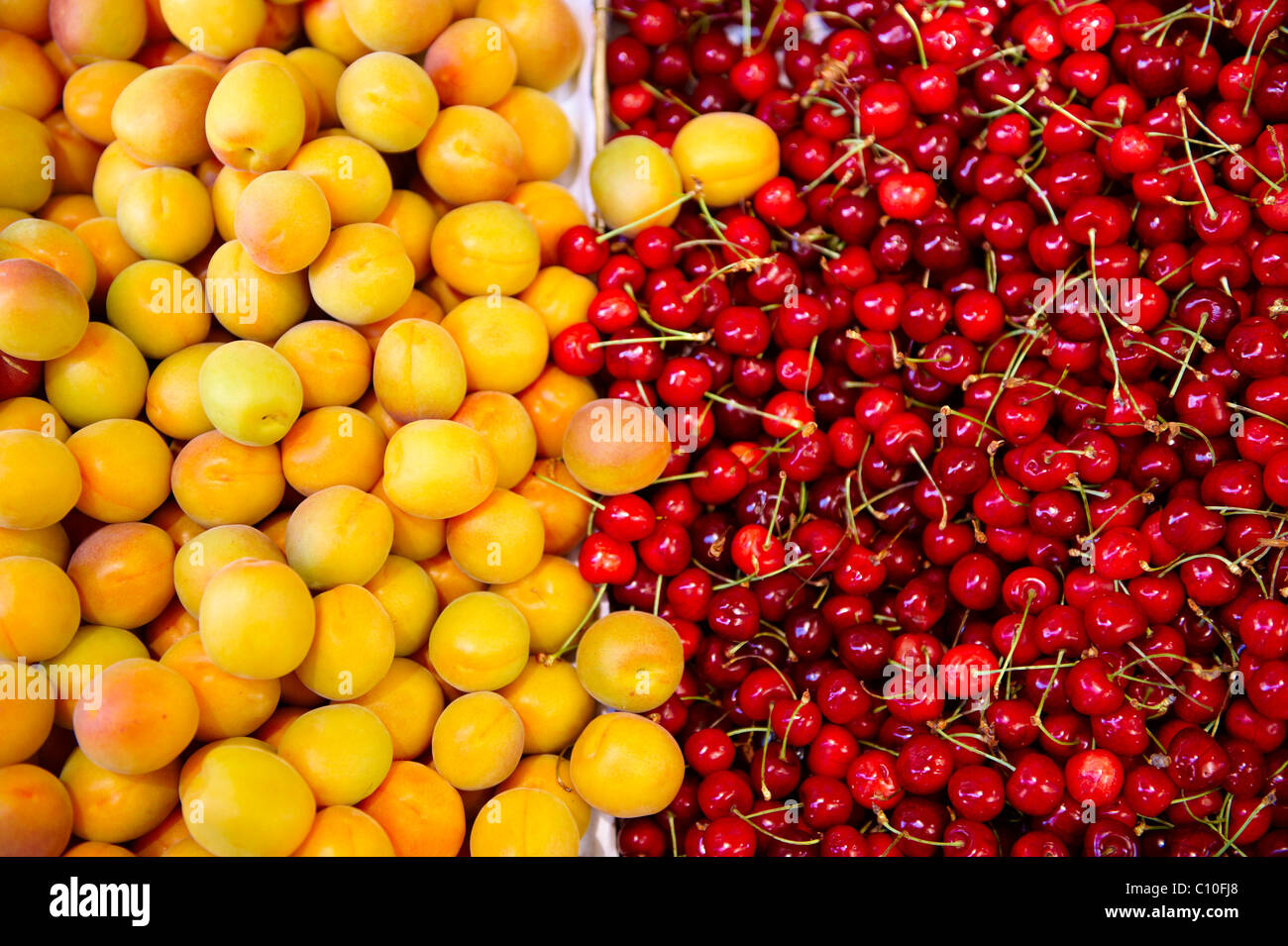 Fresh peaches, apricots & cherries on a fruit market stall, Syros, Greece Stock Photo