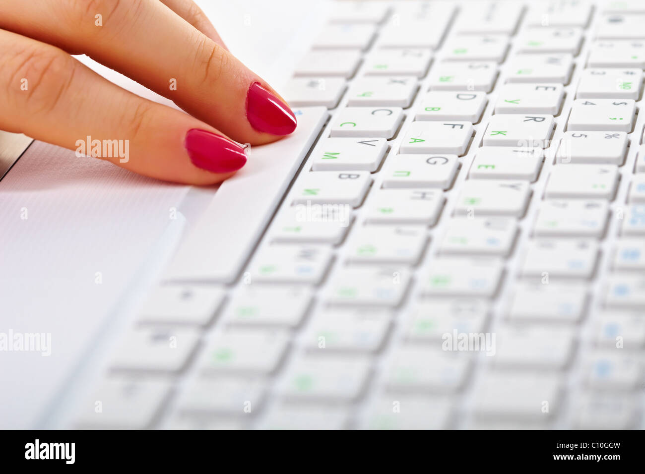 Ladies fingers on a white keyboard of laptop Stock Photo