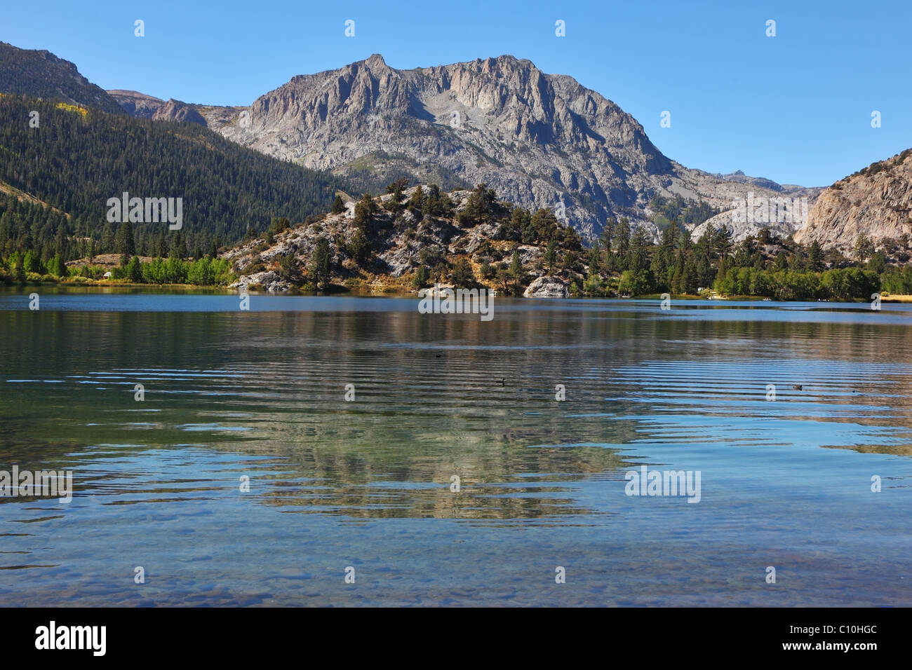 The mountains are reflected in the smooth water Stock Photo