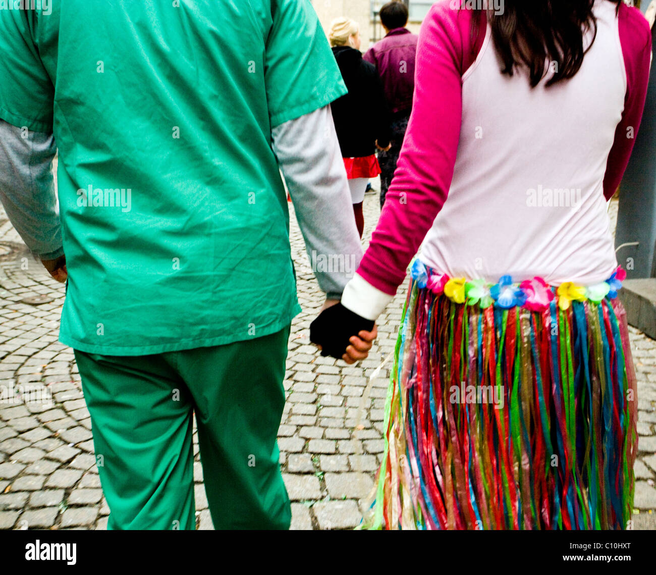 A couple wearing fancy dresses walk in the streets of Cologne during the Carnival Crazy Days in Cologne (Germany) Stock Photo