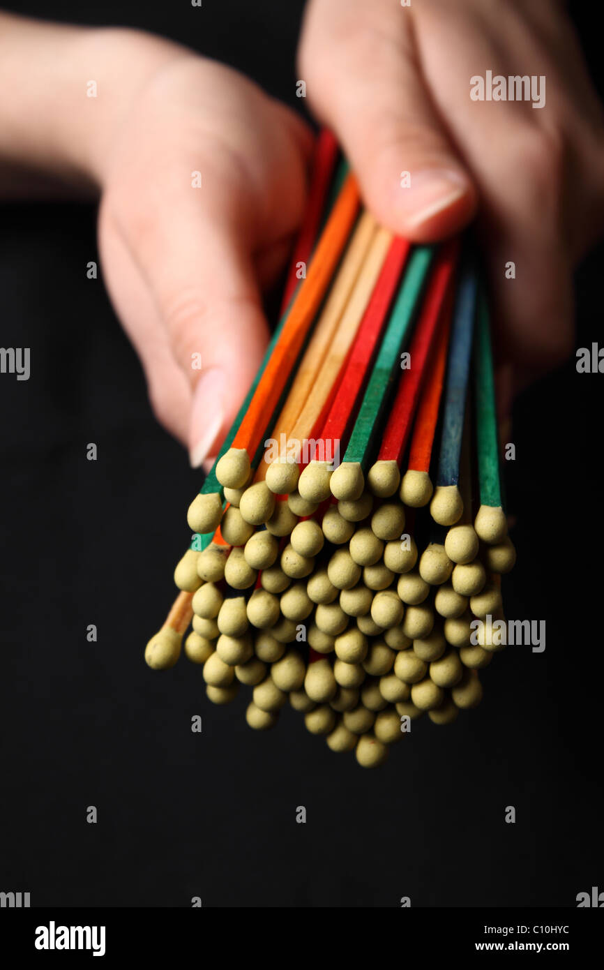 Bundle of colored matches in woman's hands Stock Photo Alamy