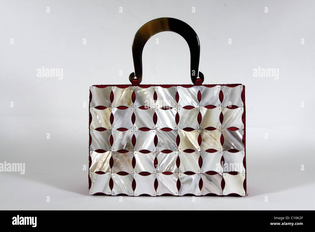 handbag with plastic shell patterns on silk, with bone handle. Stock Photo