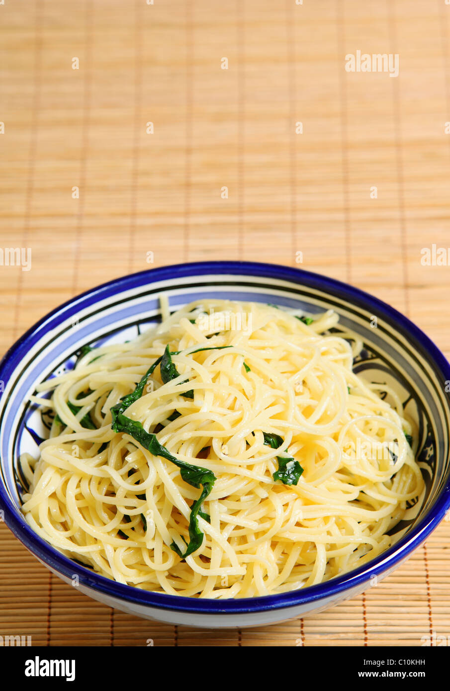 A bowl of linguine pasta with olive oil, rocket and parmesan Stock