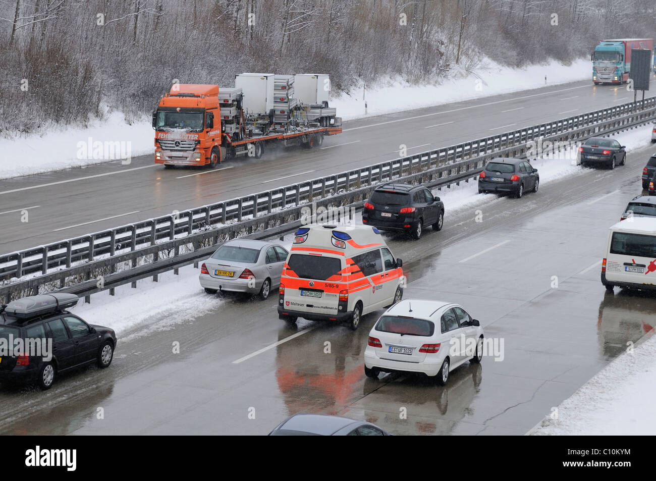 Onset of winter, Malteser vehicle on an emergency drive on the A8 motorway near Holzmaden, Baden-Wuerttemberg, Germany, Europe Stock Photo