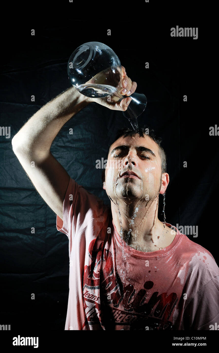 Man pouring water on his head Stock Photo Alamy