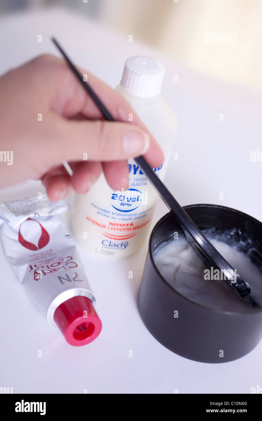 Pot filled with peroxide and hair dye color Stock Photo Alamy