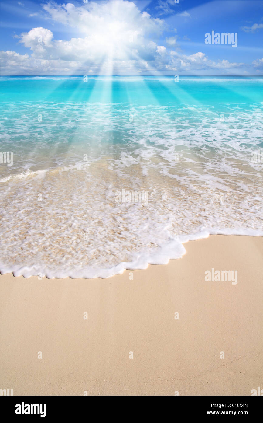 Caribbean turquoise beach sea sun beams from clouds Stock Photo
