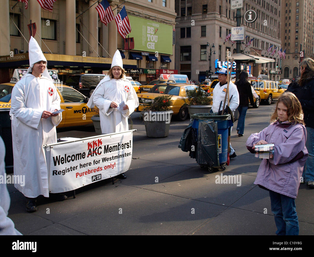 PETA members dressed in Ku Klux Klan white robes and conical hats protest outside the Westminster Kennel Club Dog Show at Stock Photo