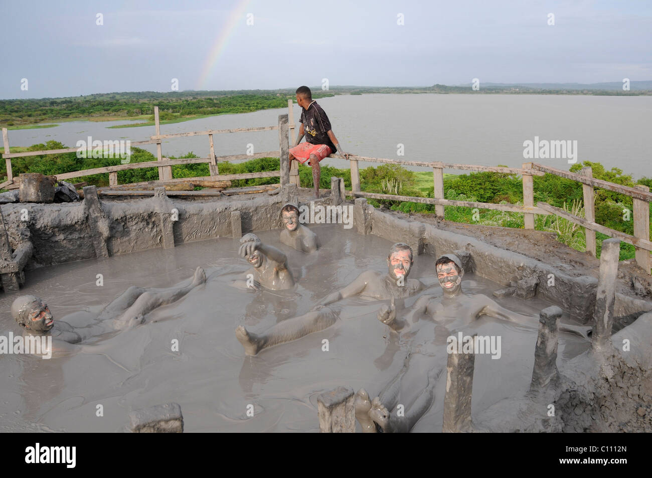 Traveller getting covered in mud while enjoying the mud baths of