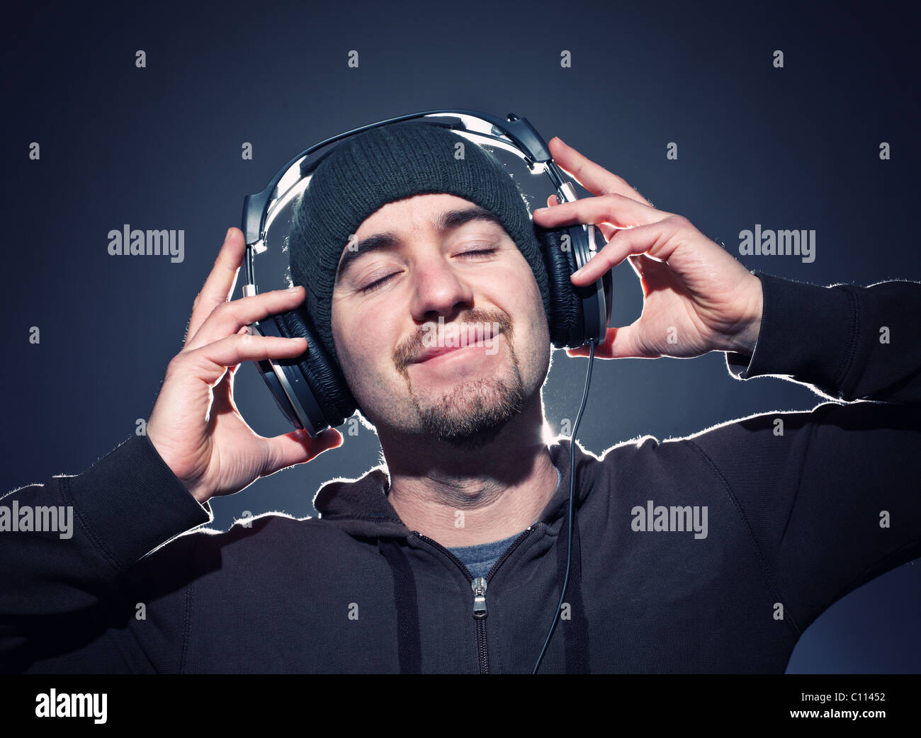 caucasian man wera cap and headphone feel the music Stock Photo