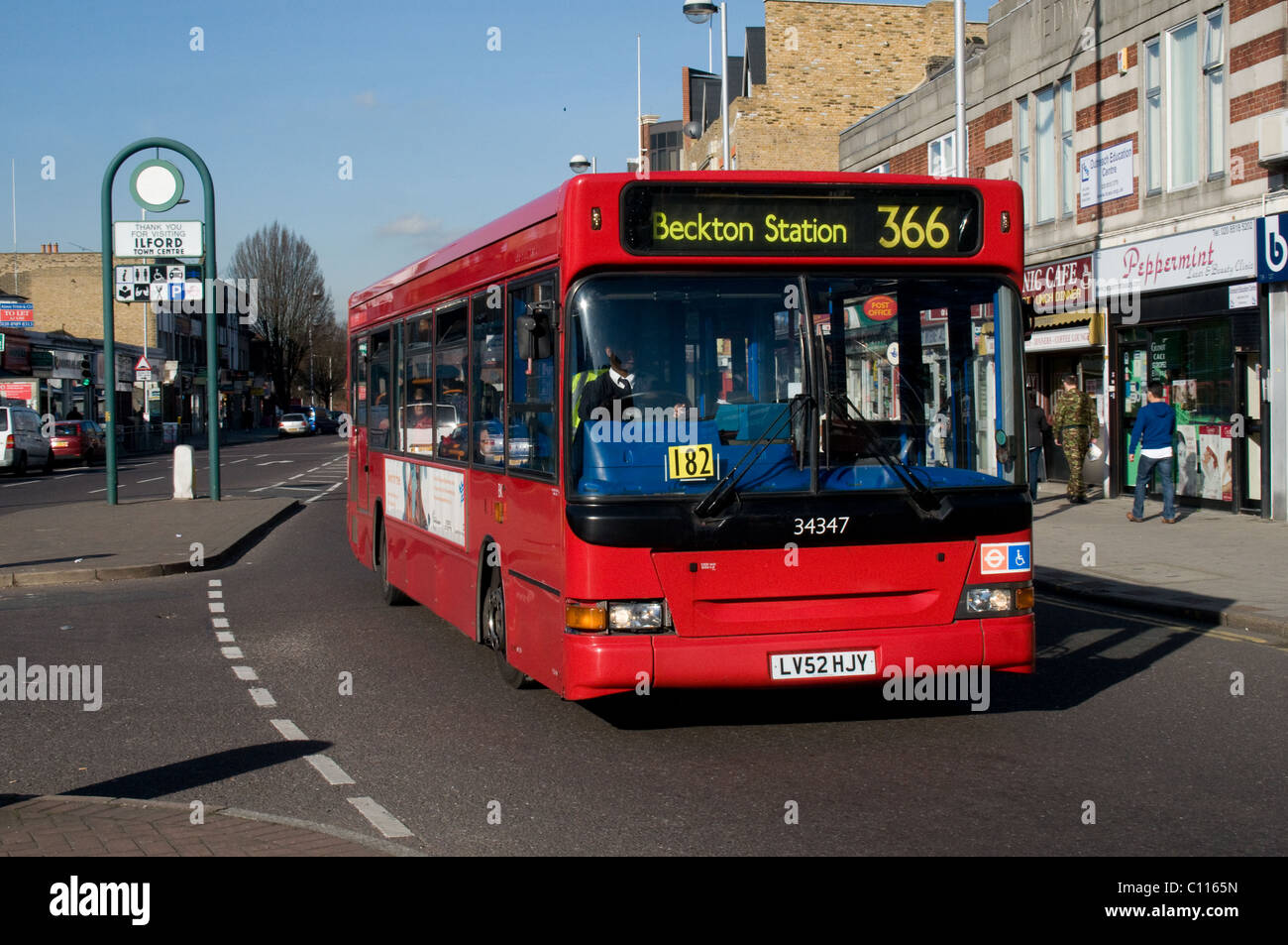 A single deck bus drives towards Ilford town center. The bus is operated by Stagecoach London. The bus is a Transbus Dart. Stock Photo