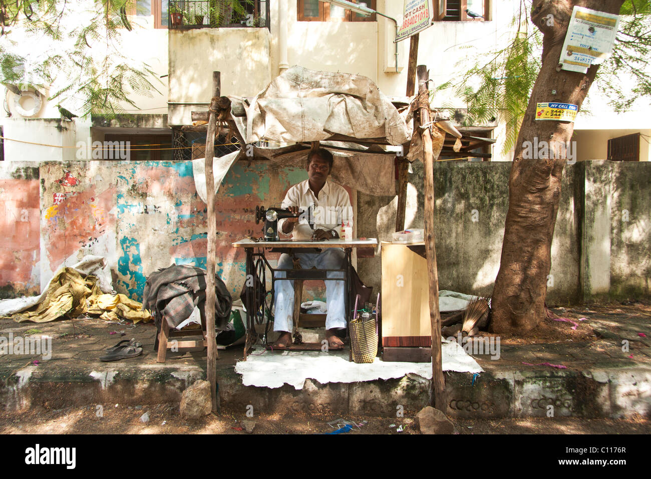 Indian tailor working on the street Stock Photo
