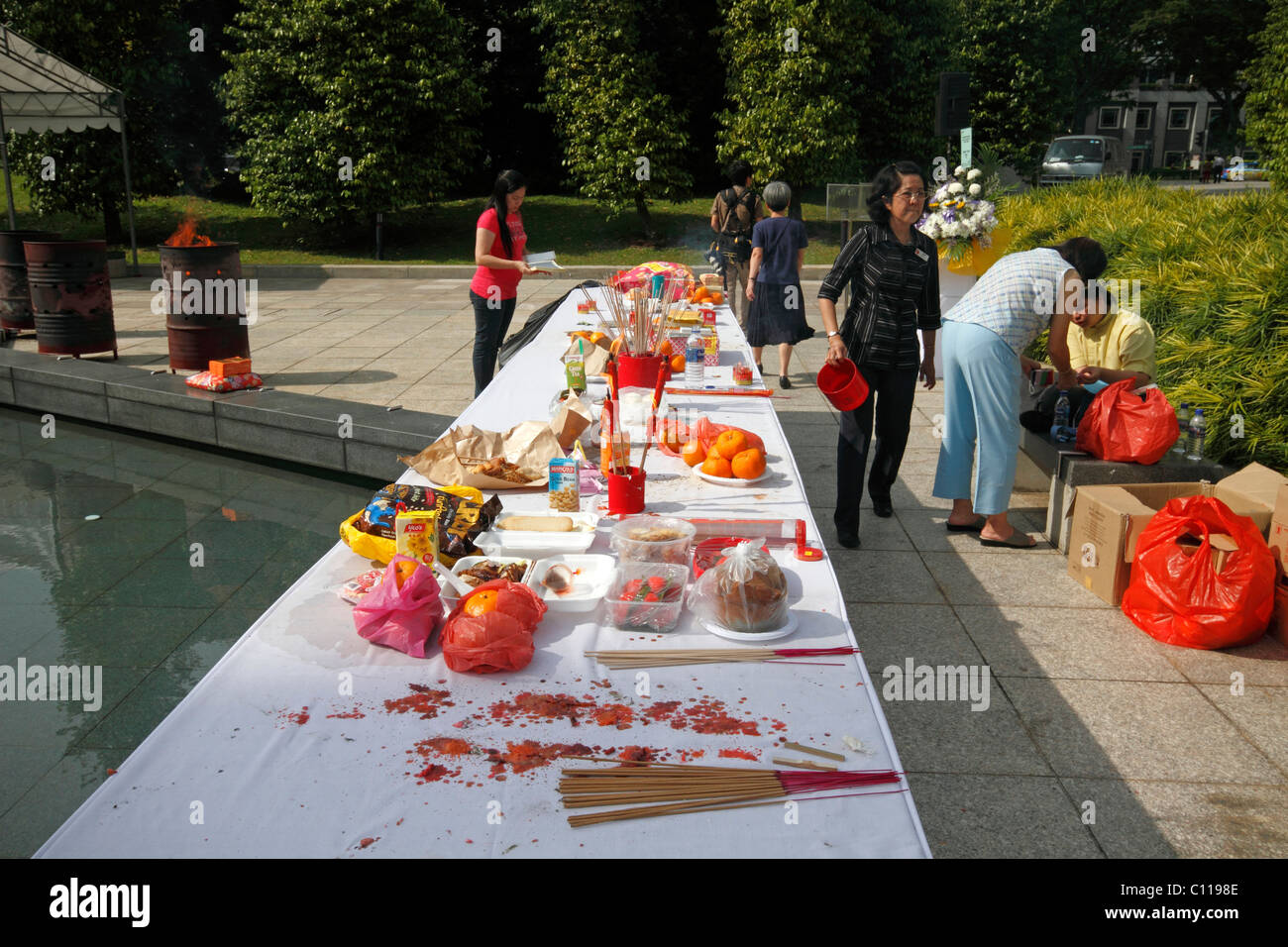 Food set out for the dead by Buddhists at  The Memorial to the Victims of the Japanese Occupation in Singapore Stock Photo