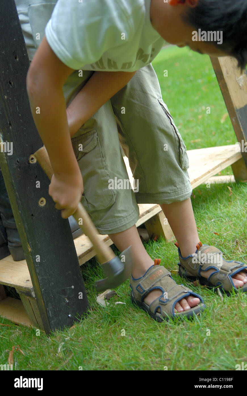 Boy hammering structure together Stock Photo Alamy