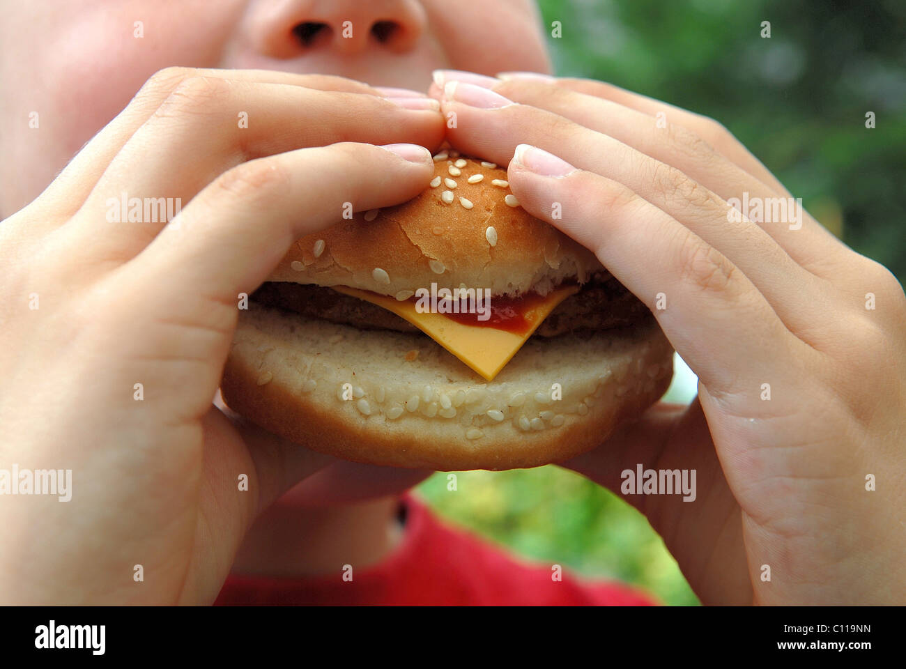 Child eating cheeseburger Stock Photo Alamy