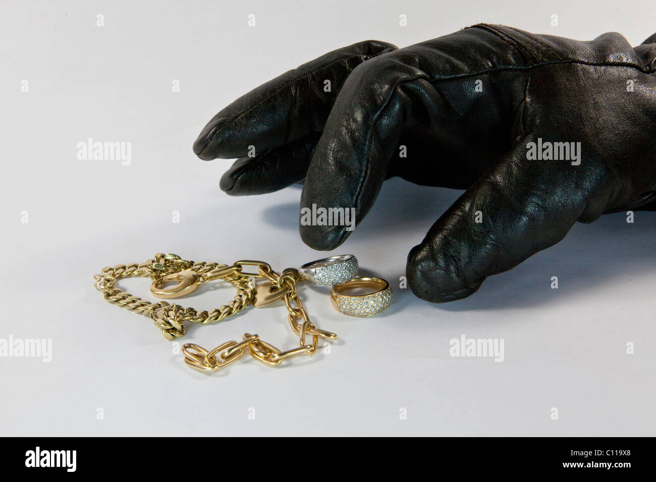 Thief with gloved hand stealing jewelry Stock Photo - Alamy