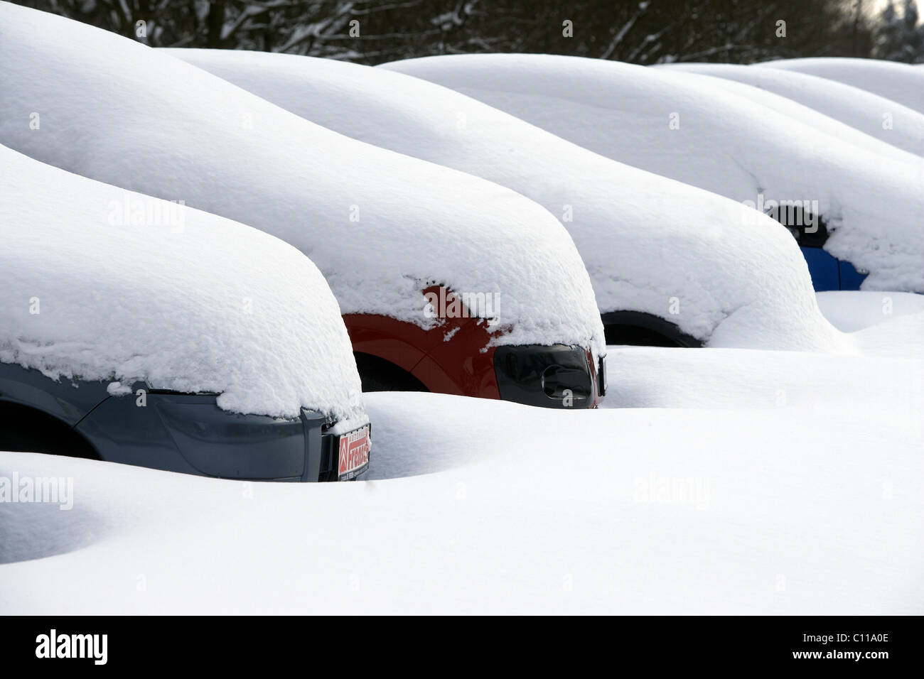 Snow-covered cars on a parking lot in Langenhahn, Rhineland-Palatinate, Germany, Europe Stock Photo