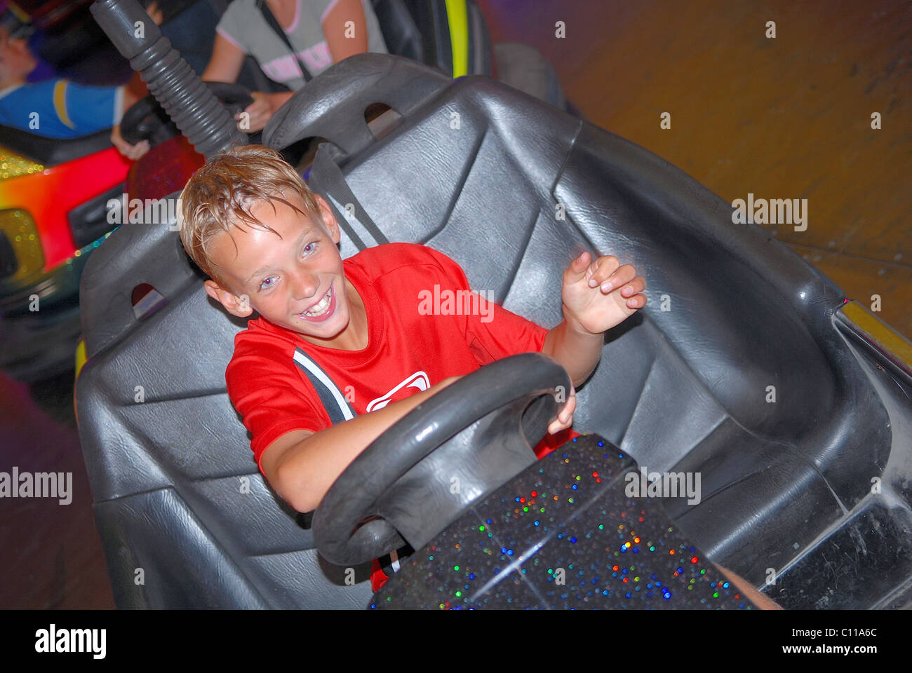 Boy driving bumper car at fairground Stock Photo Alamy