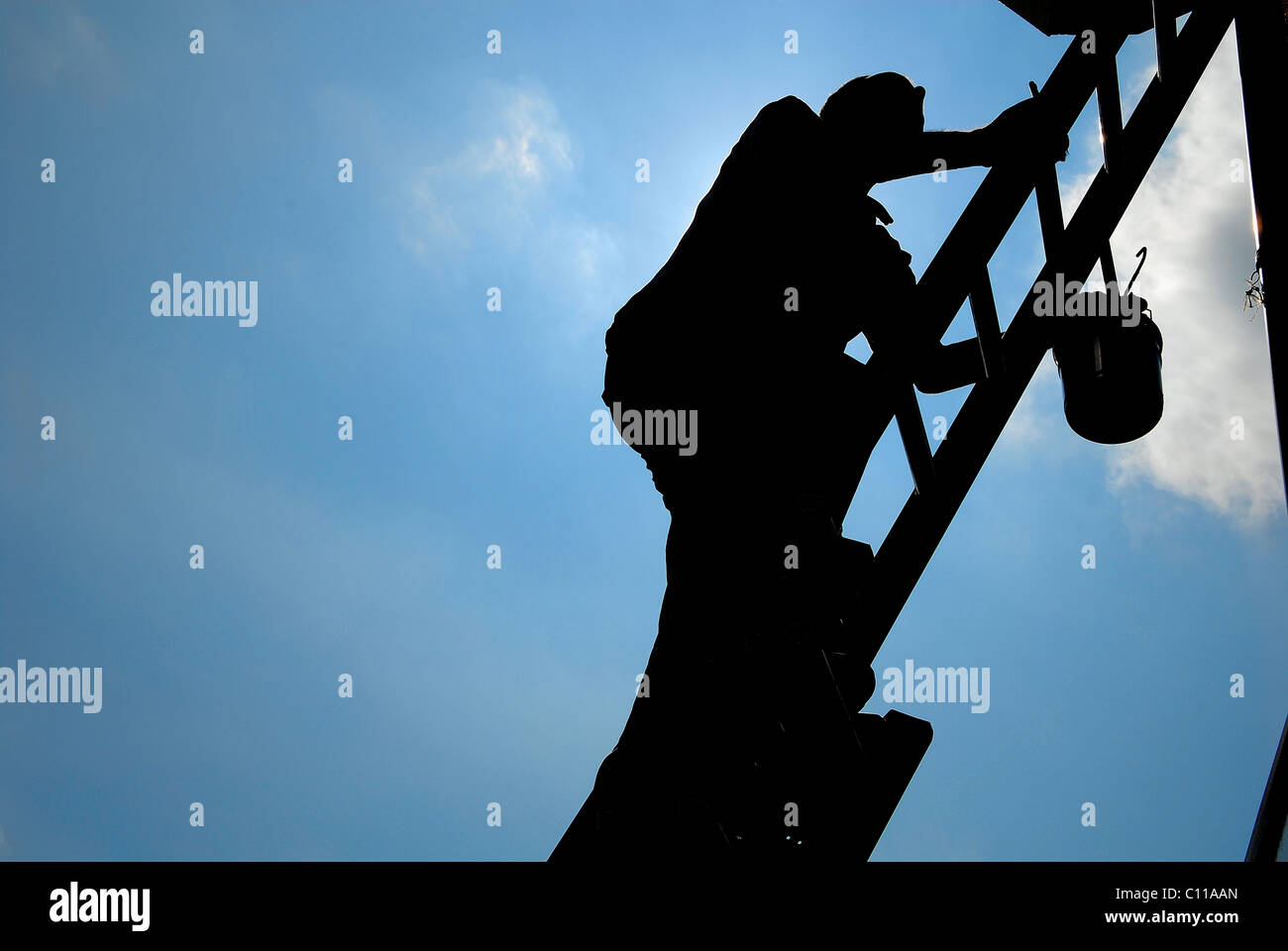 Man climbing tall ladder hi-res stock photography and images - Alamy
