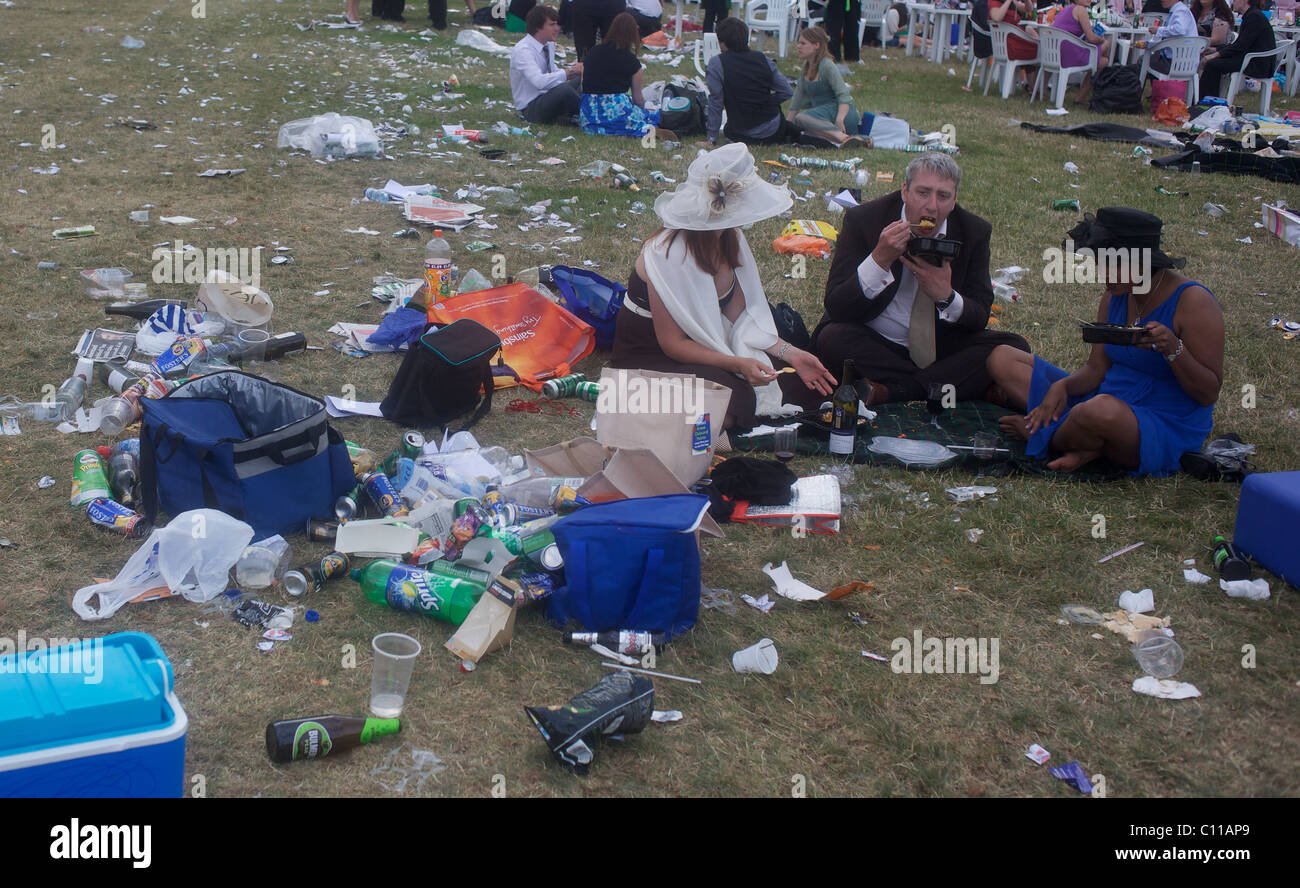 Spectators sit amongst the rubbish at the end of the Royal Ascot race meeting. Stock Photo