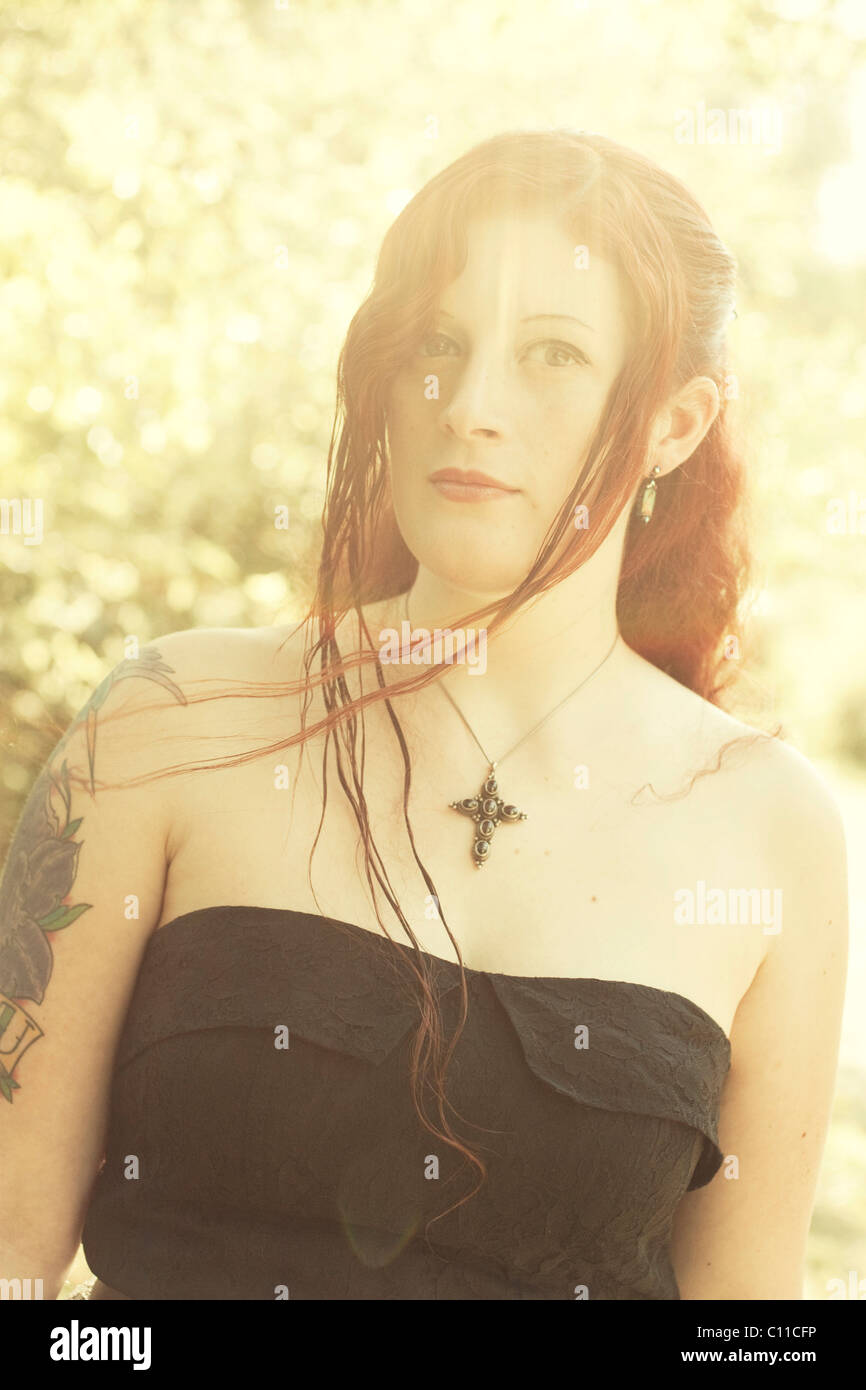 Woman, Gothic, dark hair, standing, sunlight Stock Photo Alamy