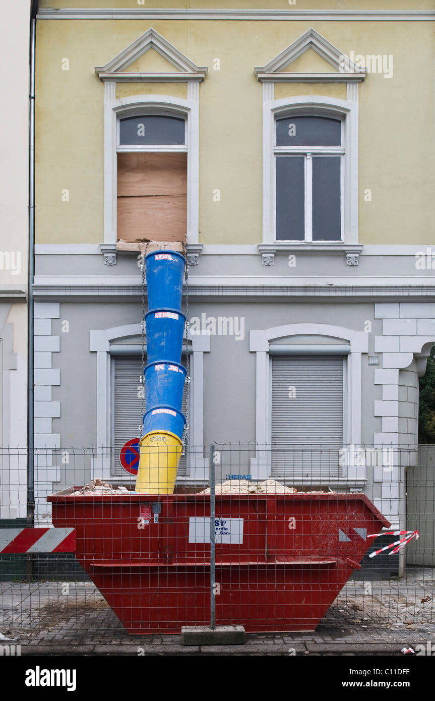 Skip Pipe Skip with dump pipe outside a house which is being renovated ...