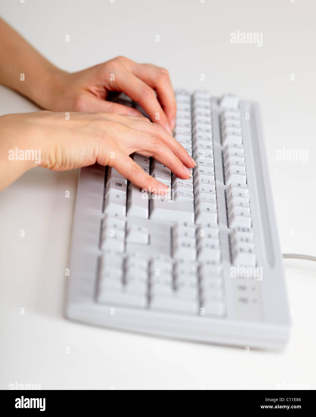 Female hands working with computer keyboard Stock Photo