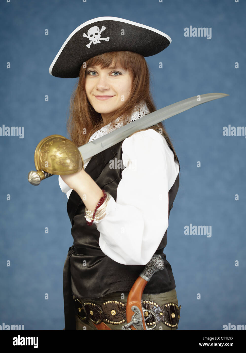 Beautiful woman in clothes of pirate on blue background Stock Photo