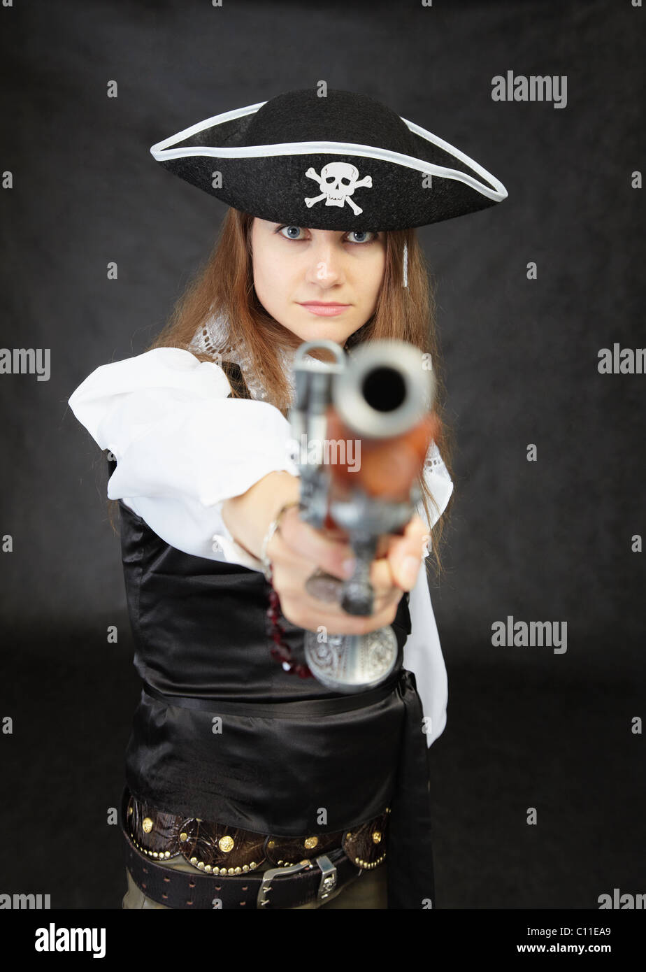 Woman pirate aims in us from an ancient pistol Stock Photo