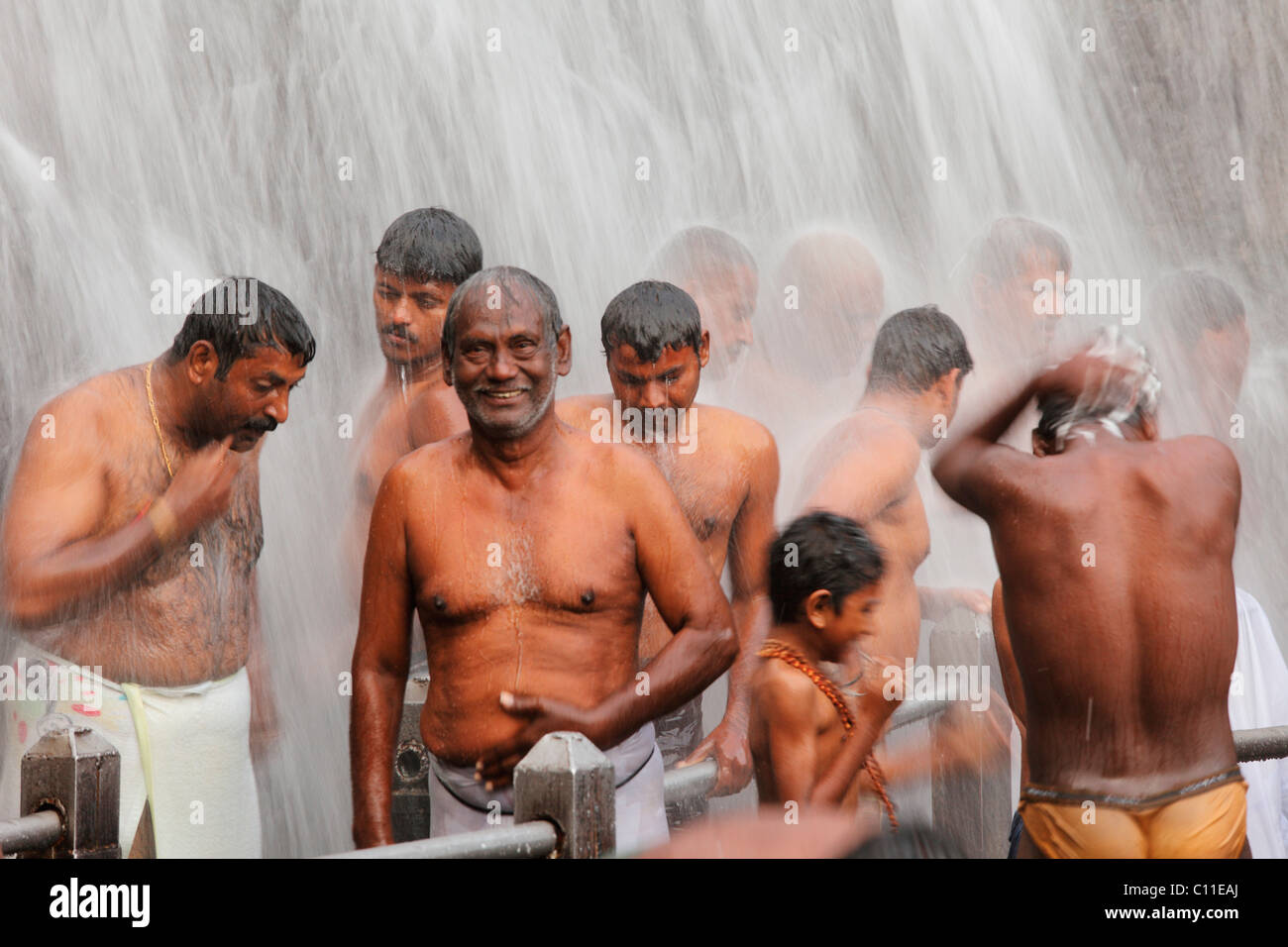 Men washing themselves in the Kutralam Waterfalls, Peraruvi, Main Falls, Kuttralam, Kuttalam, Courtallam, Western Ghats Stock Photo
