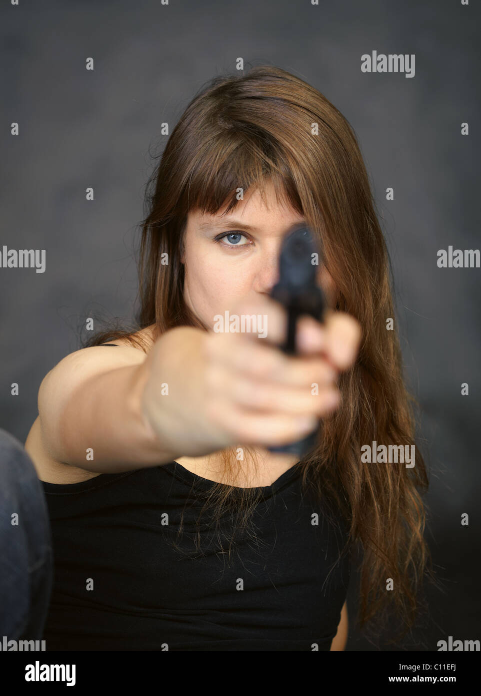 Woman aiming in enemy from pistol Stock Photo
