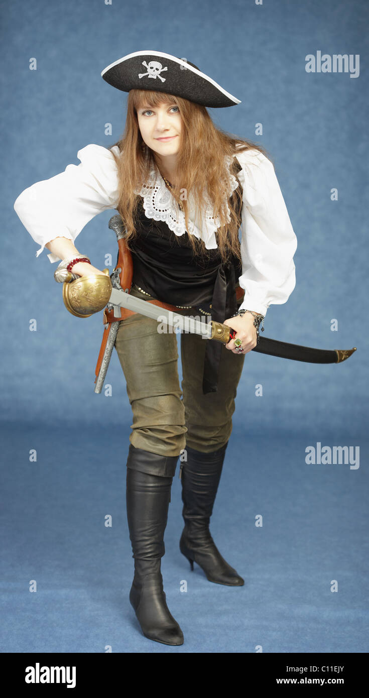 Young woman in clothes of pirate on blue background Stock Photo