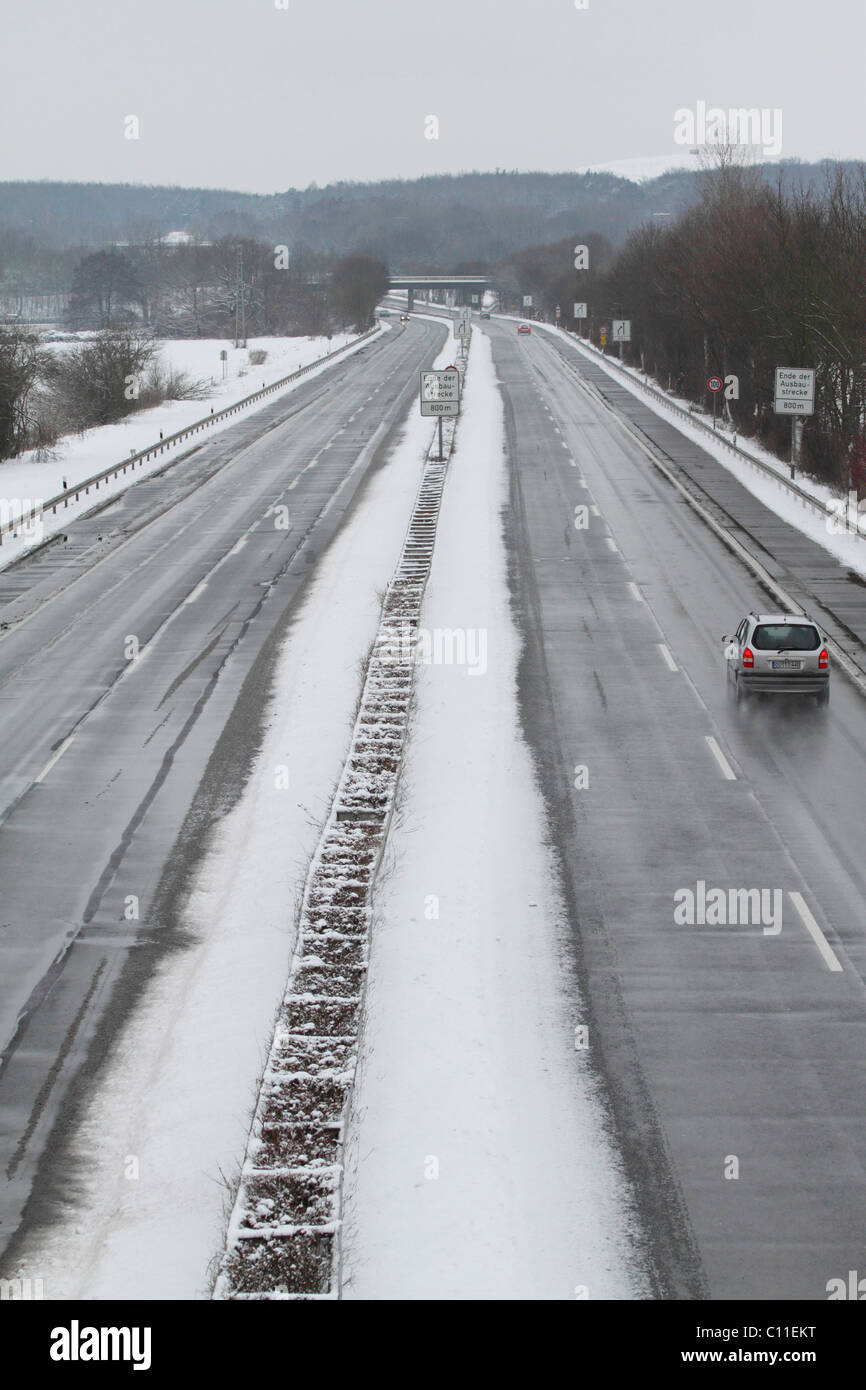 B448 highway with narrowing of the road and speed restriction signs, winter, Hesse, Germany Stock Photo